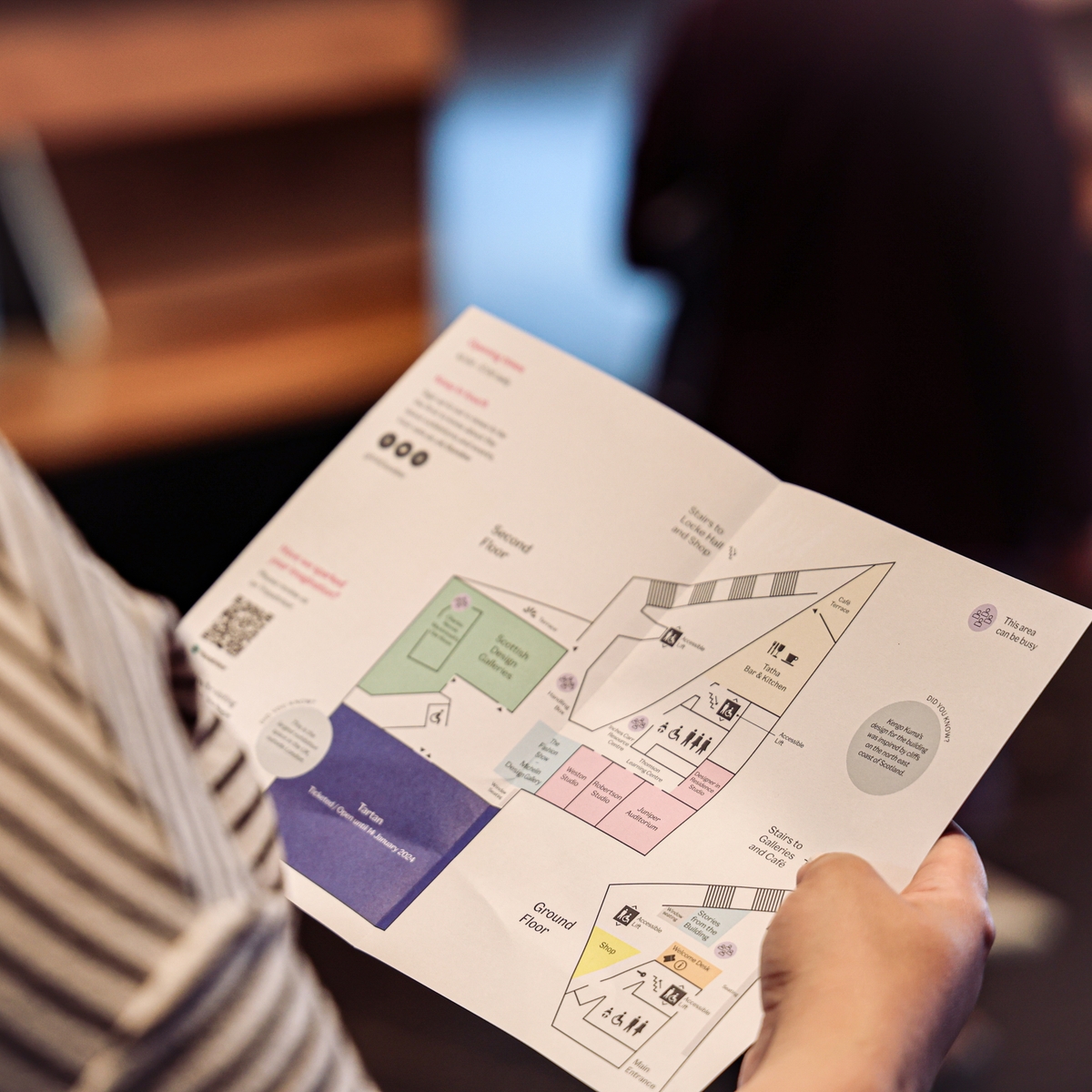 A woman holding a map at V&A Dundee