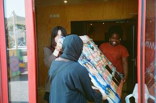 People carrying an artwork